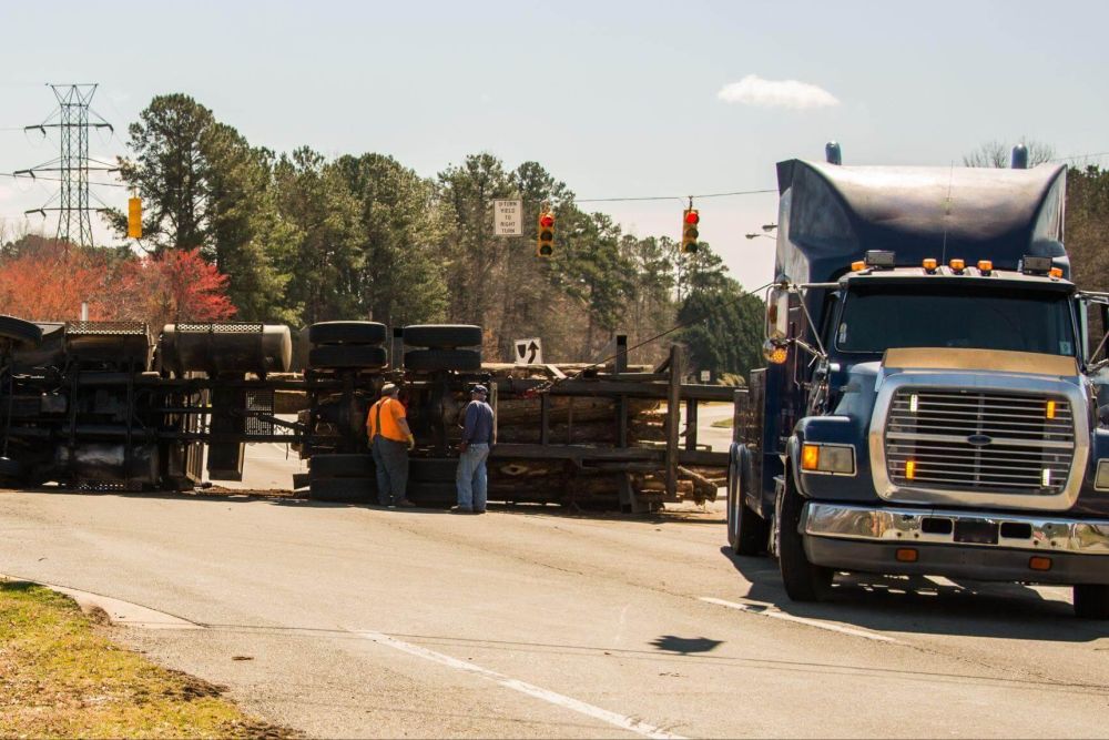 Two men next to a large truck on a