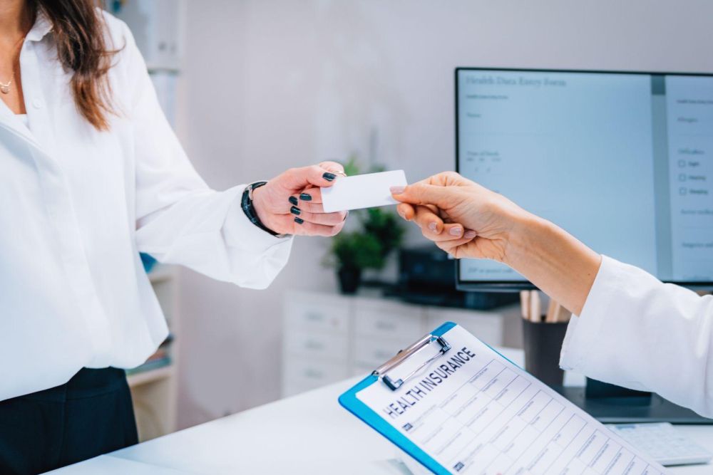 A person handing a business card, symbolizing professional advice