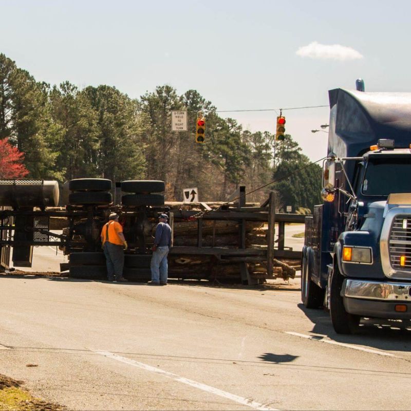 Two men next to a large truck on a