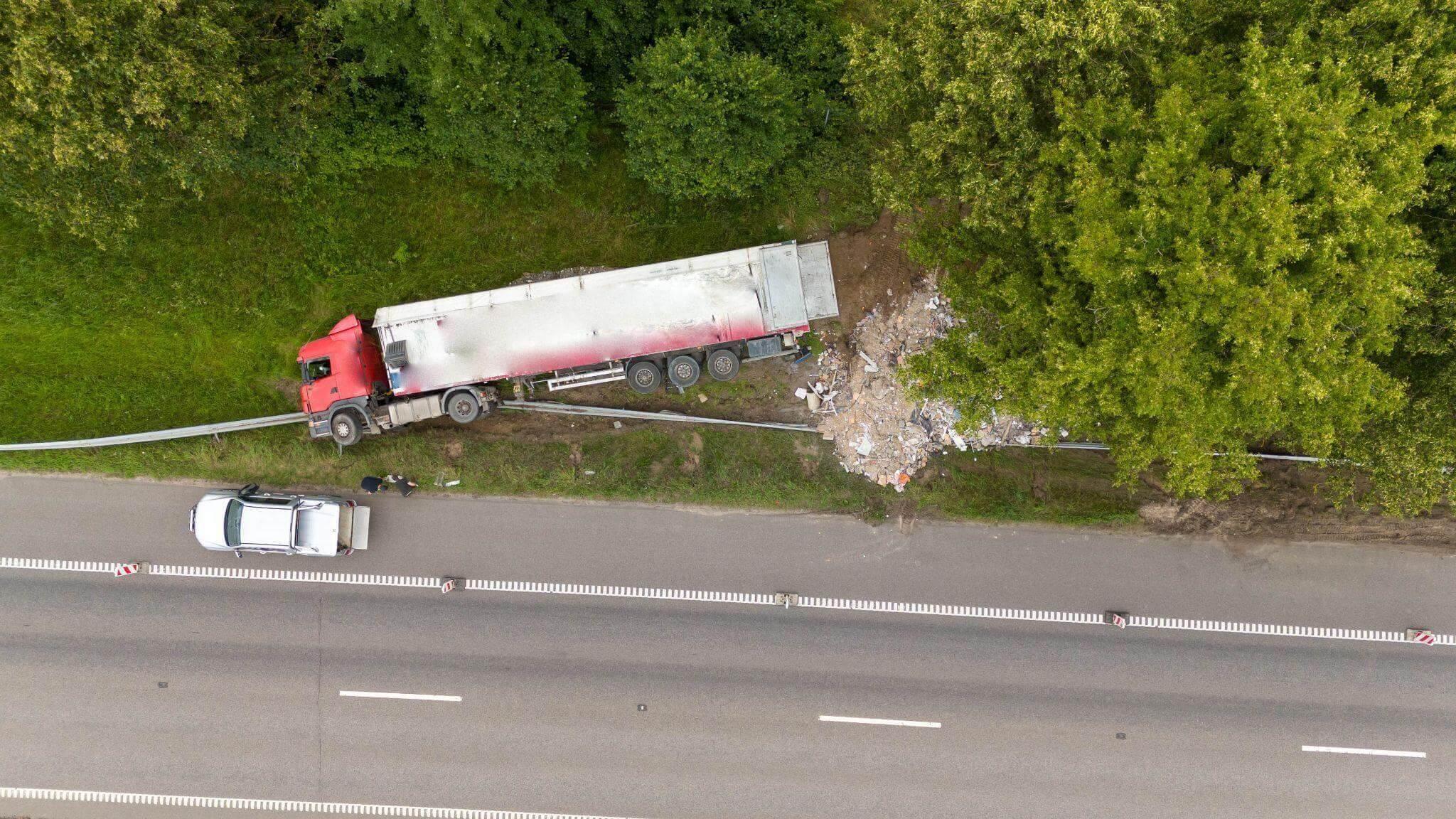 a truck that has crashed on the side of the road