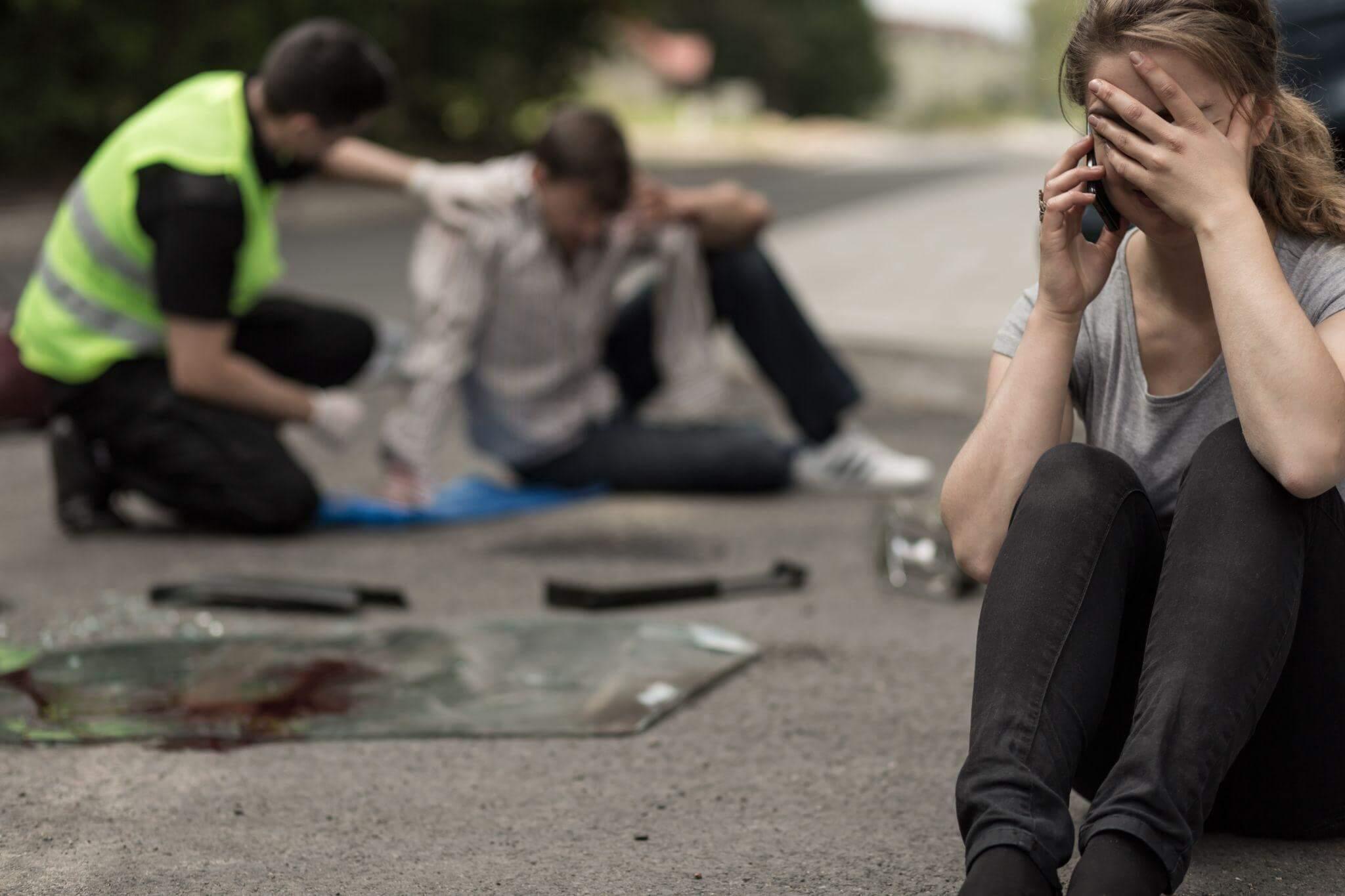 Group of people sitting closely together on the ground