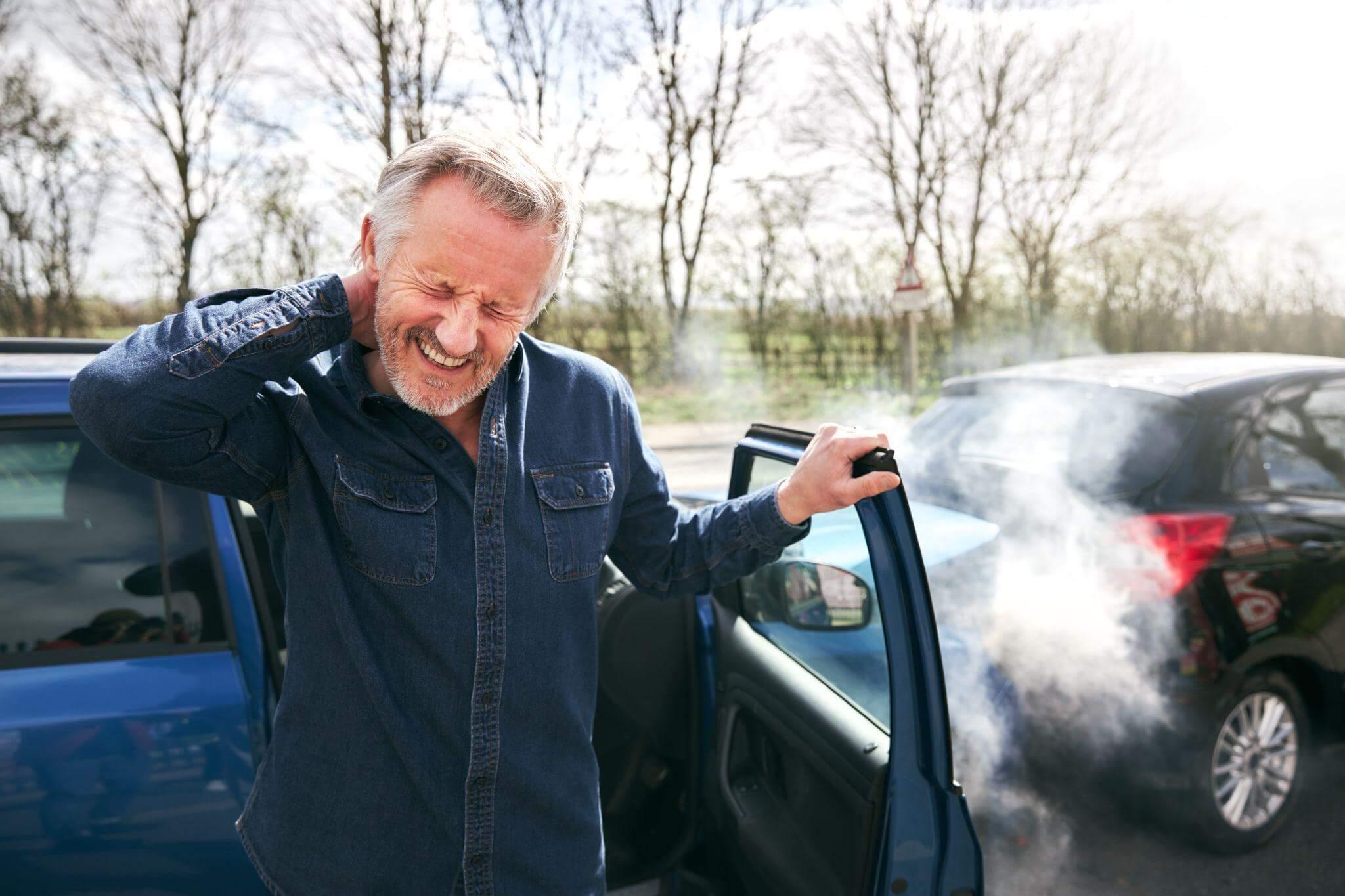 Man exiting a car with smoke