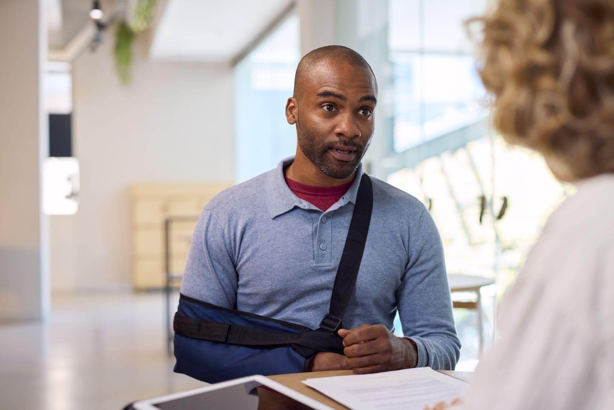 Man discussing injury with woman after seeking personal injury attorney