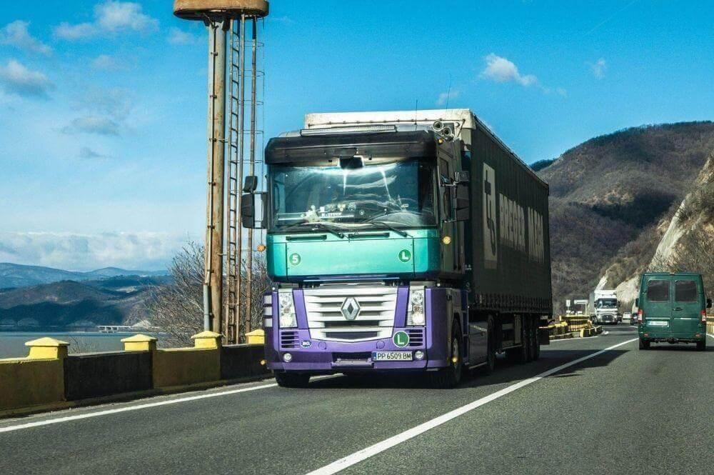 Truck driving on a California road next to a