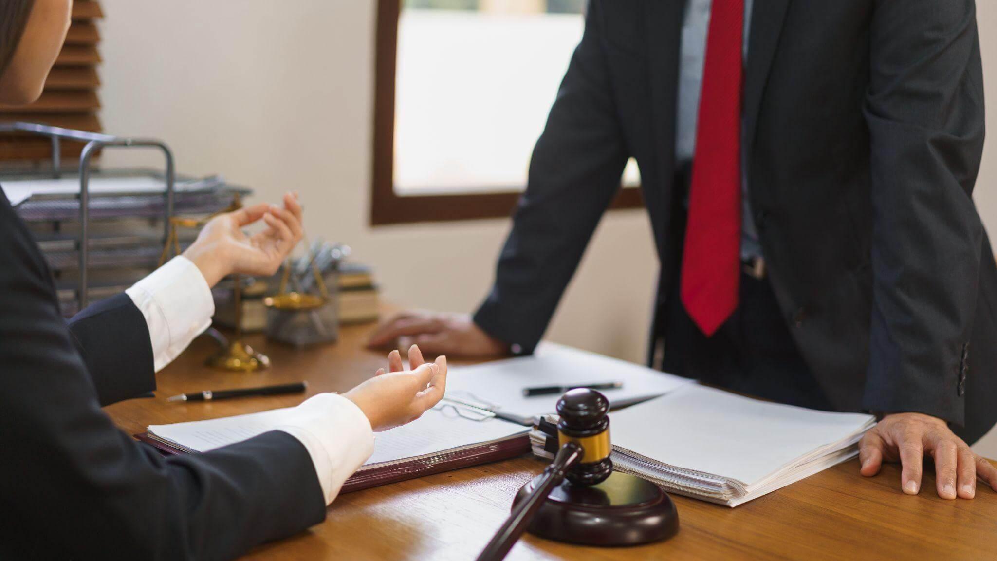 Two people sitting at a table discussing personal injury claim