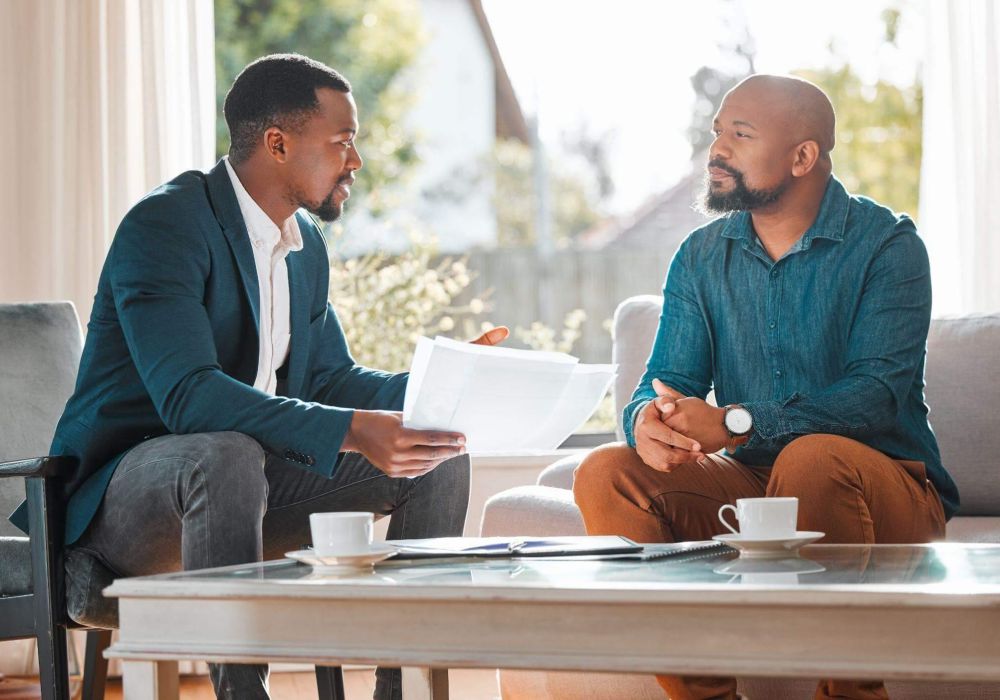 a couple of men sitting on top of a couch